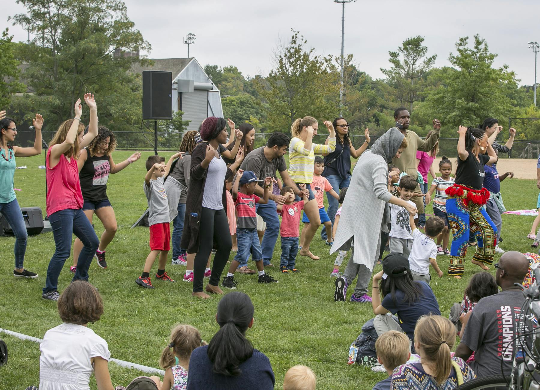 Several children and parents are dancing outside at Denehy Park family fun day