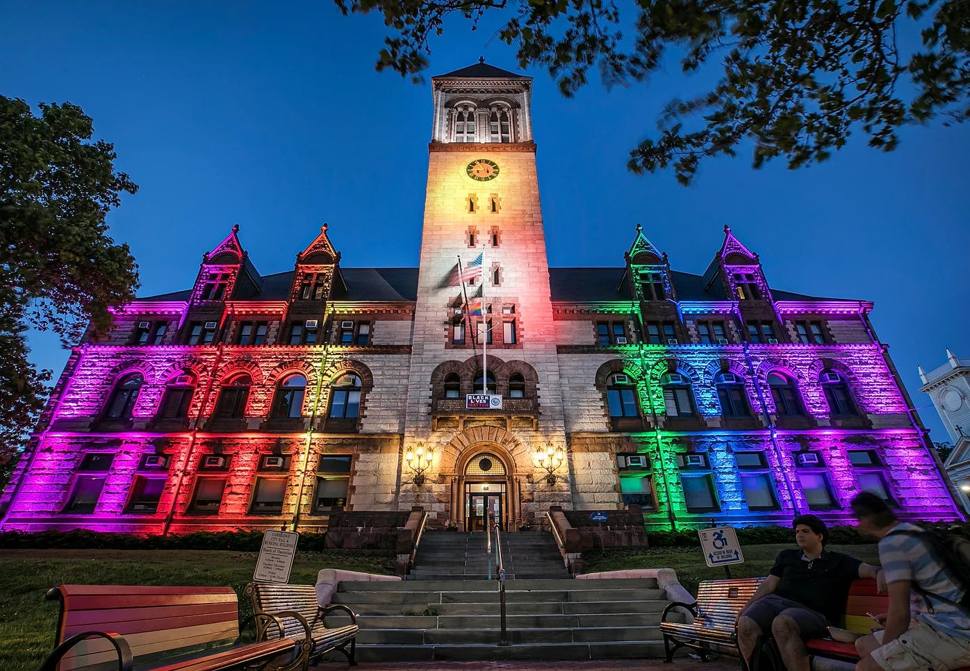 Cambridge city hall at night illuminated with rainbow color lights